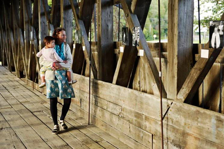 Kathryn and Azalea Cole view images from The Nomadic Photo Ark exhibit at Sanborn Covered Bridge
